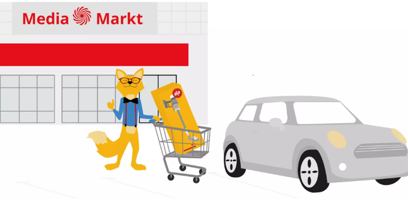 Der Smart Home Fox Fuchs steht mit einem Einkaufswagen vor einem Elektrogeschäft